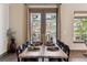 Dining area featuring a wood table and access to a patio with a garden view at 24322 E Mineral Dr, Aurora, CO 80016