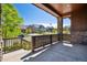 Covered front porch with stone pillars and a view of the charming neighborhood street at 24322 E Mineral Dr, Aurora, CO 80016