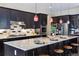 Modern kitchen with granite countertops, dark cabinetry, and stainless steel appliances at 24322 E Mineral Dr, Aurora, CO 80016