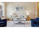 Bright living room with neutral tones, a comfortable sofa, stylish decor, and natural light streaming through the window at 24322 E Mineral Dr, Aurora, CO 80016