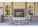 Outdoor seating area with a fireplace, stone accents, and beautiful views of the landscape, perfect for relaxation at 24322 E Mineral Dr, Aurora, CO 80016