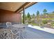 Covered deck with iron railing offers relaxing outdoor space with views of the landscaped backyard at 24322 E Mineral Dr, Aurora, CO 80016