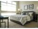 Comfortable bedroom with a large window, plush bed, and elegant decor at 2879 W Parkside Pl, Denver, CO 80221