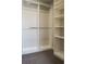 Spacious walk-in closet featuring built-in shelving and ample storage space at 2879 W Parkside Pl, Denver, CO 80221