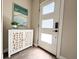 Modern entryway with a decorative cabinet, wall art, and stylish front door at 2879 W Parkside Pl, Denver, CO 80221