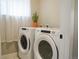 Bright laundry room equipped with modern washer and dryer units at 2879 W Parkside Pl, Denver, CO 80221