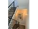 Carpeted staircase with black metal railings and a framed picture on the neutral-colored wall for added elegance at 2879 W Parkside Pl, Denver, CO 80221