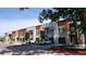 Modern townhomes boast stylish exteriors with a combination of gray brick, light beige stucco, and warm wood accents at 2879 W Parkside Pl, Denver, CO 80221