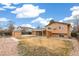 View of the backyard with detached shed and covered patio area at 16652 E Gunnison Pl, Aurora, CO 80017