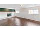Finished basement with cozy fireplace, brick surround and modern, stylish flooring at 16652 E Gunnison Pl, Aurora, CO 80017