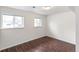 This bedroom has beautiful wood-look flooring and two windows allowing for natural light at 16652 E Gunnison Pl, Aurora, CO 80017