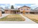 Exterior shot of the house featuring a covered patio area, a lawn and an attached garage at 16652 E Gunnison Pl, Aurora, CO 80017