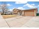 Two-story home with brick and siding, attached garage and concrete driveway at 16652 E Gunnison Pl, Aurora, CO 80017