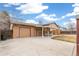 The house has an attached garage and a long driveway with an overhang at 16652 E Gunnison Pl, Aurora, CO 80017