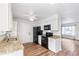 Well-lit kitchen featuring granite countertops, white cabinets, and modern black appliances at 16652 E Gunnison Pl, Aurora, CO 80017