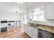Bright kitchen with granite counters, stainless steel appliances, and view to adjacent dining area at 16652 E Gunnison Pl, Aurora, CO 80017