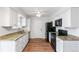 Modern kitchen showcasing stainless steel appliances, granite countertops, and bright white cabinetry at 16652 E Gunnison Pl, Aurora, CO 80017
