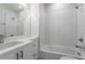 Bright bathroom with white subway tile, white vanity, and a deep soaking tub at 2350 Tremont Pl # 19, Denver, CO 80205