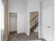 Carpeted bedroom featuring closet with sliding doors, stairs and white doors at 2350 Tremont Pl # 19, Denver, CO 80205