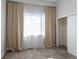 Bright bedroom featuring plush carpet, window with curtains, and closet with sliding doors at 2350 Tremont Pl # 19, Denver, CO 80205