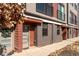 Townhome entrance with brick accents and an inviting front door with a holiday wreath at 2350 Tremont Pl # 19, Denver, CO 80205