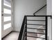 Bright entryway features modern door with sidelights and sleek black railing at 2350 Tremont Pl # 19, Denver, CO 80205