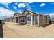 Backyard of home with slider and covered patio at 19060 E 96Th Pl, Commerce City, CO 80022