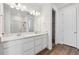 Bathroom with double sink vanity, quartz countertops, and glass shower at 19060 E 96Th Pl, Commerce City, CO 80022
