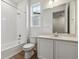 Bright bathroom featuring a shower-tub combo, white vanity, and wood-look flooring for a modern touch at 19060 E 96Th Pl, Commerce City, CO 80022