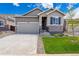 Charming single Gathering home with stone accents, attached garage, manicured lawn, and beautiful landscaping at 19060 E 96Th Pl, Commerce City, CO 80022