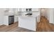 Modern kitchen boasts white cabinets, stainless steel appliances, and hard surface countertops, blending style and functionality at 19060 E 96Th Pl, Commerce City, CO 80022