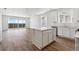 Bright kitchen with island, modern appliances, and hardwood floors offering a spacious and open layout at 19060 E 96Th Pl, Commerce City, CO 80022