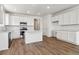 Modern kitchen boasts white cabinets, stainless steel appliances, and hard surface countertops, blending style and functionality at 19060 E 96Th Pl, Commerce City, CO 80022