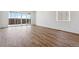 Bright living room with wood flooring and sliding glass doors to bring the outside in at 19060 E 96Th Pl, Commerce City, CO 80022