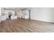 Open-concept floor plan with living room flowing into kitchen area featuring stainless steel appliances at 19060 E 96Th Pl, Commerce City, CO 80022