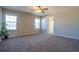 Bright bedroom with two windows, ceiling fan, and access to bathroom at 5471 Scenic Ave, Firestone, CO 80504