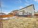 Backyard featuring a patio, fire pit, and deck with metal railings off the main level at 8236 E 137Th Dr, Thornton, CO 80602