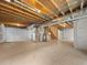 Unfinished basement with exposed wood beams, and utilities, ready to be finished to your liking at 8236 E 137Th Dr, Thornton, CO 80602