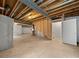 Unfinished basement with exposed beams, concrete walls and floor, with walk up stairwell to the main floor at 8236 E 137Th Dr, Thornton, CO 80602