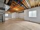 Unfinished basement with exposed wood beams, concrete walls and floor, and small windows at 8236 E 137Th Dr, Thornton, CO 80602