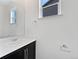 Bright bathroom with a modern sink, vanity, mirror, and fixtures at 8236 E 137Th Dr, Thornton, CO 80602