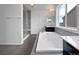 Luxurious bathroom with a soaking tub, glass shower, and dual vanities for a spa-like experience at 8236 E 137Th Dr, Thornton, CO 80602