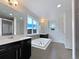 Bright bathroom featuring a large soaking tub, double sink vanity, and modern finishes at 8236 E 137Th Dr, Thornton, CO 80602