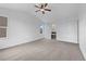 Bright bedroom with neutral carpet, ceiling fan, and ensuite bathroom entrance at 8236 E 137Th Dr, Thornton, CO 80602