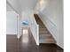 Bright entryway featuring hardwood floors, stairs to the second level, and an open floor plan at 8236 E 137Th Dr, Thornton, CO 80602