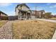 Charming two-story home featuring a red front door, stone accents, and a well-maintained lawn at 8236 E 137Th Dr, Thornton, CO 80602