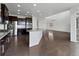 Modern kitchen flows into the living area with stainless steel appliances, and granite countertops at 8236 E 137Th Dr, Thornton, CO 80602
