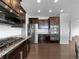 Kitchen showcasing stainless steel appliances, granite countertops, and dark wood cabinets at 8236 E 137Th Dr, Thornton, CO 80602