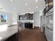 Modern kitchen with dark cabinetry, stainless steel appliances, granite countertops, and recessed lighting at 8236 E 137Th Dr, Thornton, CO 80602