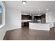 Open-concept kitchen with granite countertops, stainless steel appliances, and dark wood cabinetry at 8236 E 137Th Dr, Thornton, CO 80602